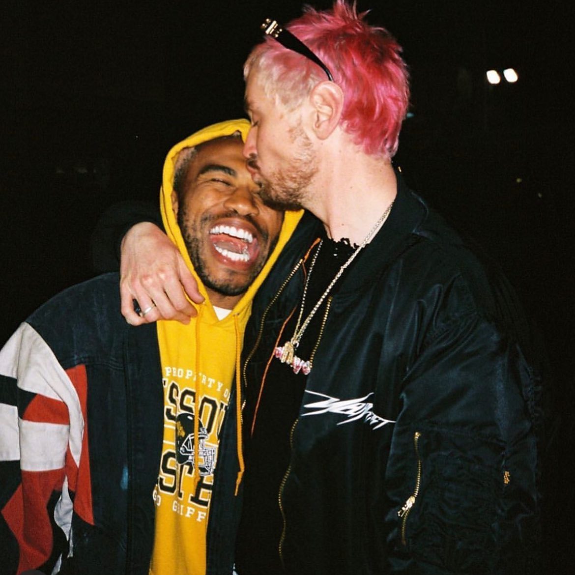 Nick Holiday kissing his boyfriend, Kevin Abstract, on his forehead