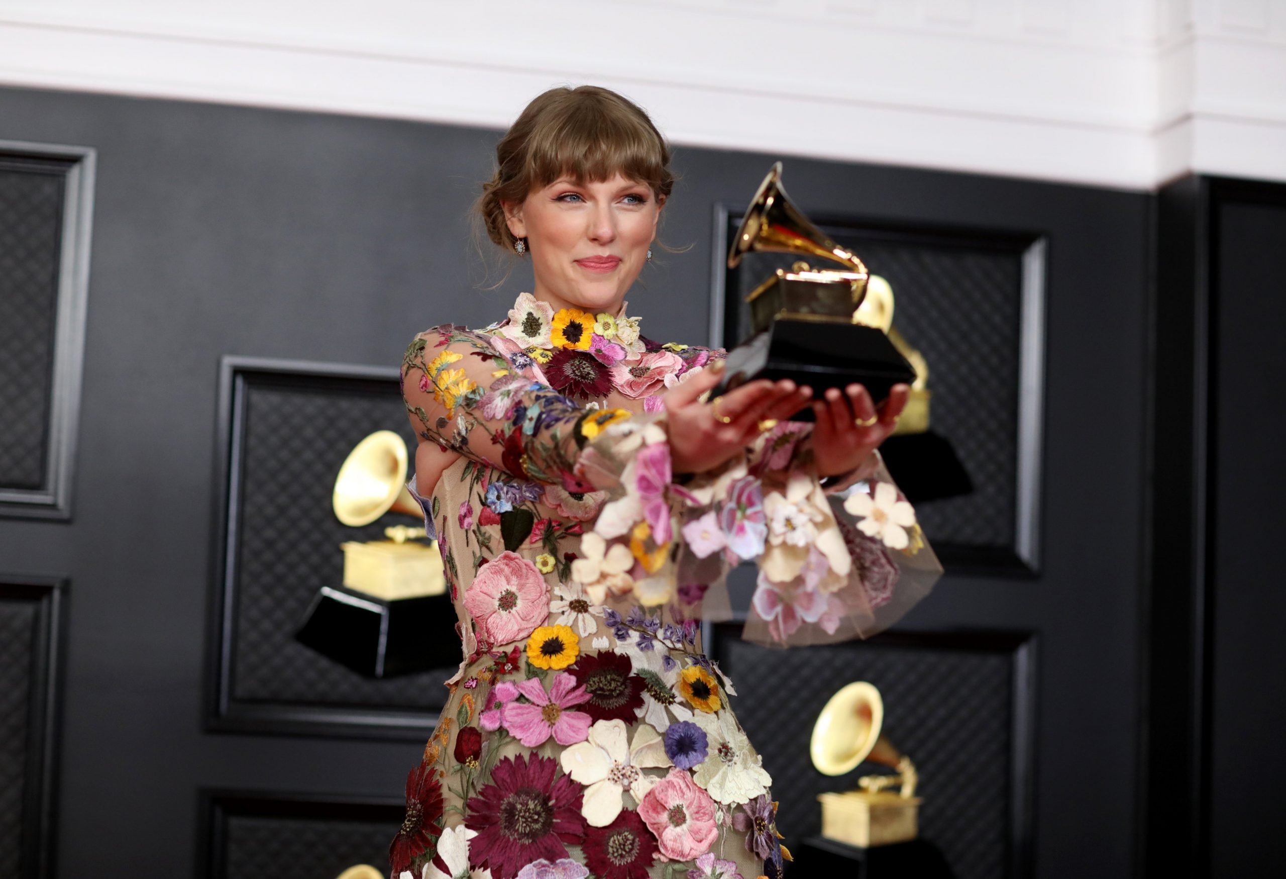 Taylor Swift backstage at the 2021 Grammy's with her award for Album of the Year – "folklore"
