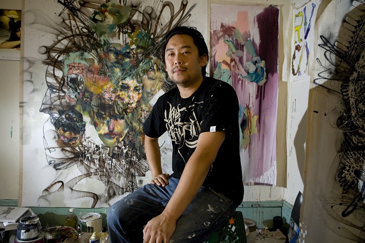 David Choe is pictured in front of his artwork. 