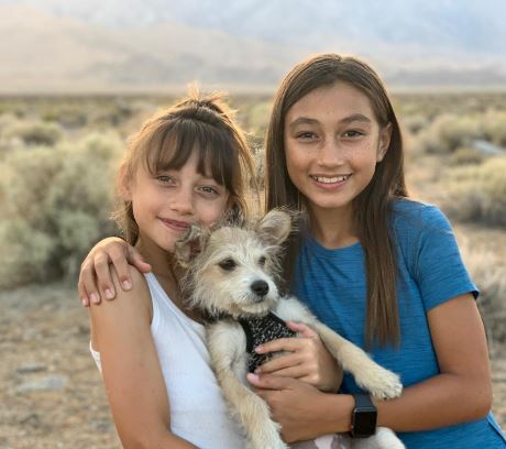 Maya Le Clark with her sister Olivia and their dog Lulu Bear.
