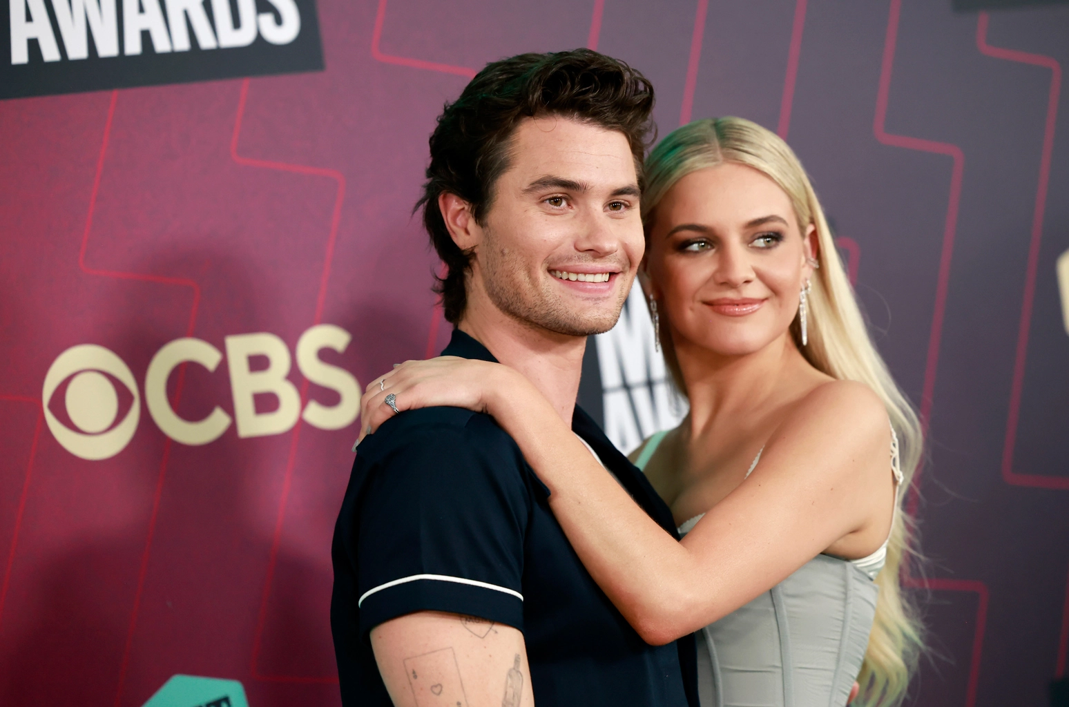 Chase Stokes and Kelsey Ballerini arm in arm at the 2023 CMT Music Awards.