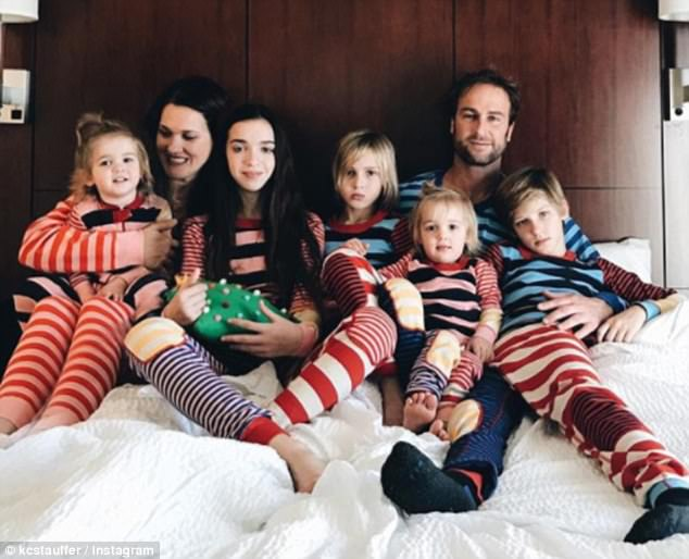 Katie Stauffer and Charley are pictured with their five kids. 