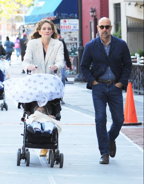 Stanley Tucci and Felicity Blunt walking their son Matteo.