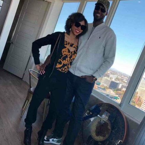 Kwame Brown smiling with his wife