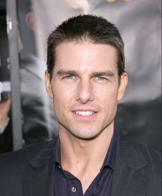 Tom Cruise eye color are blueish-green with a yellow ring around the pupil.