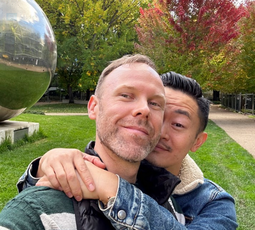Picture of Benjamin Law embracing his partner Scott Spark (Source: Instagram)