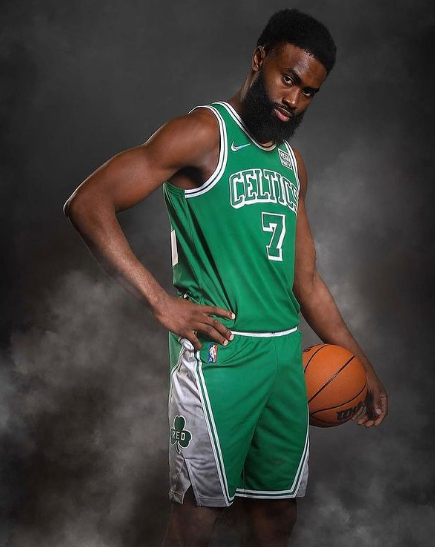 Jaylen Brown posing with a basketball 